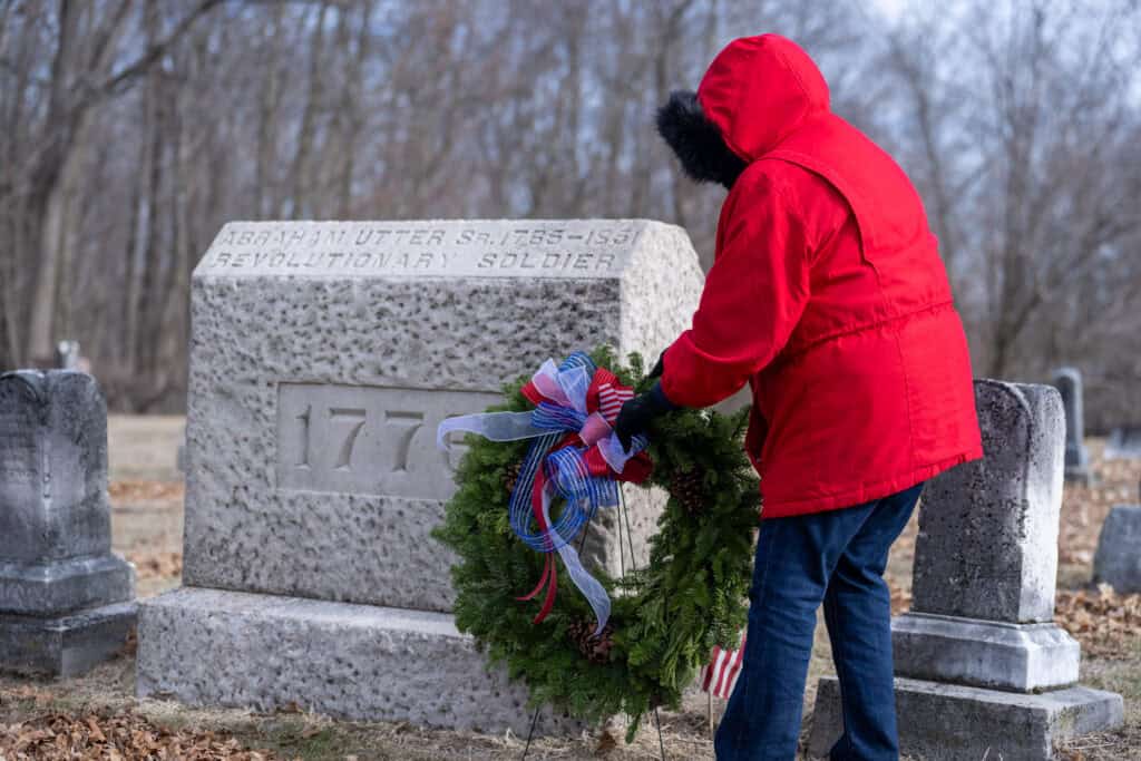 Laying a wreath at a revolutionary war veteran's grave.